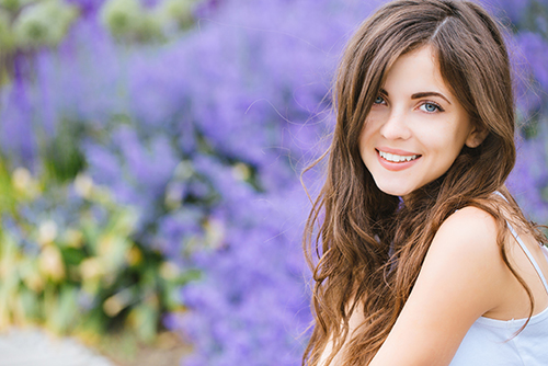 Portrait of a beautiful young student girl in the park outdoors